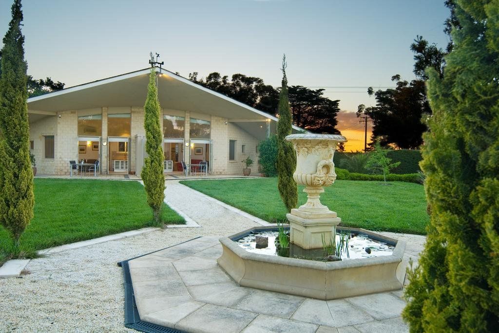 The Gatehouse at Villa Capra at sunset with the garden fountain